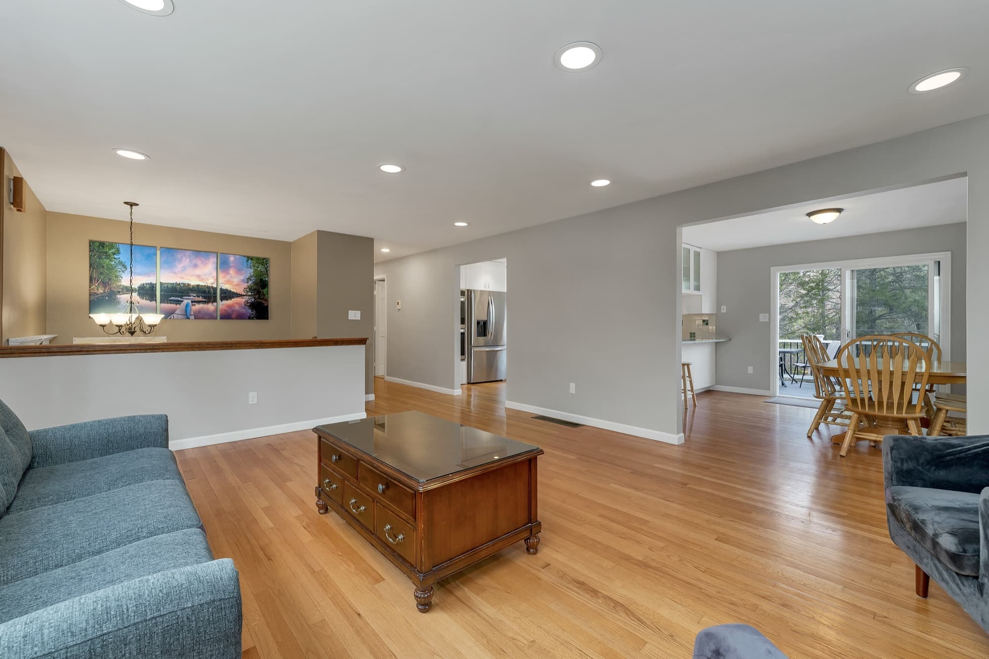 Living room with hardwood floors, open through to the kitchen and dining area